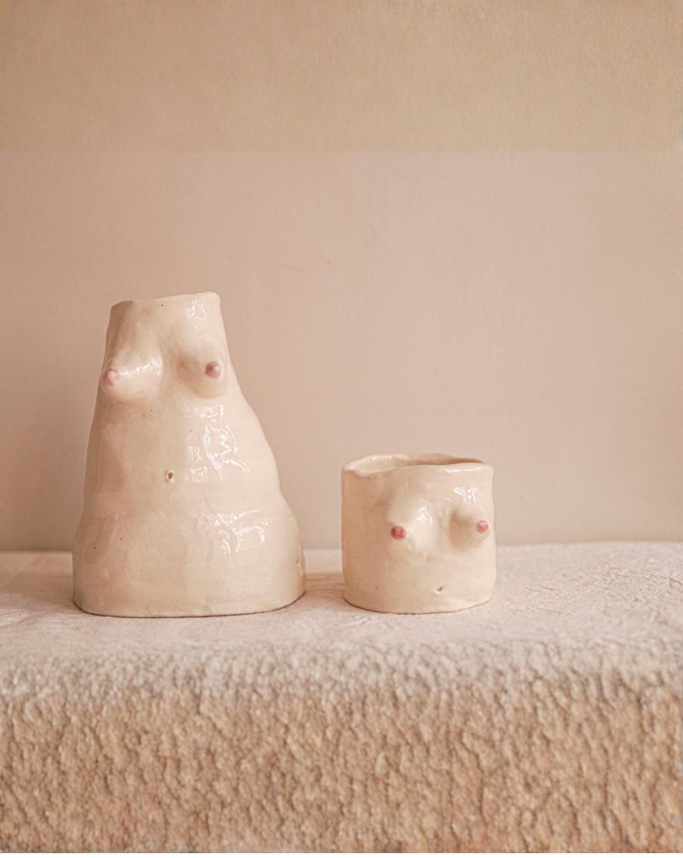 Handmade ceramic vessels on a linen shelf in the studio